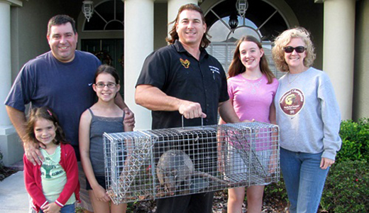 Pest Control in Lutz Florida Happy Lutz Family Posing with Pest Control Expert and Armadillo He Caught